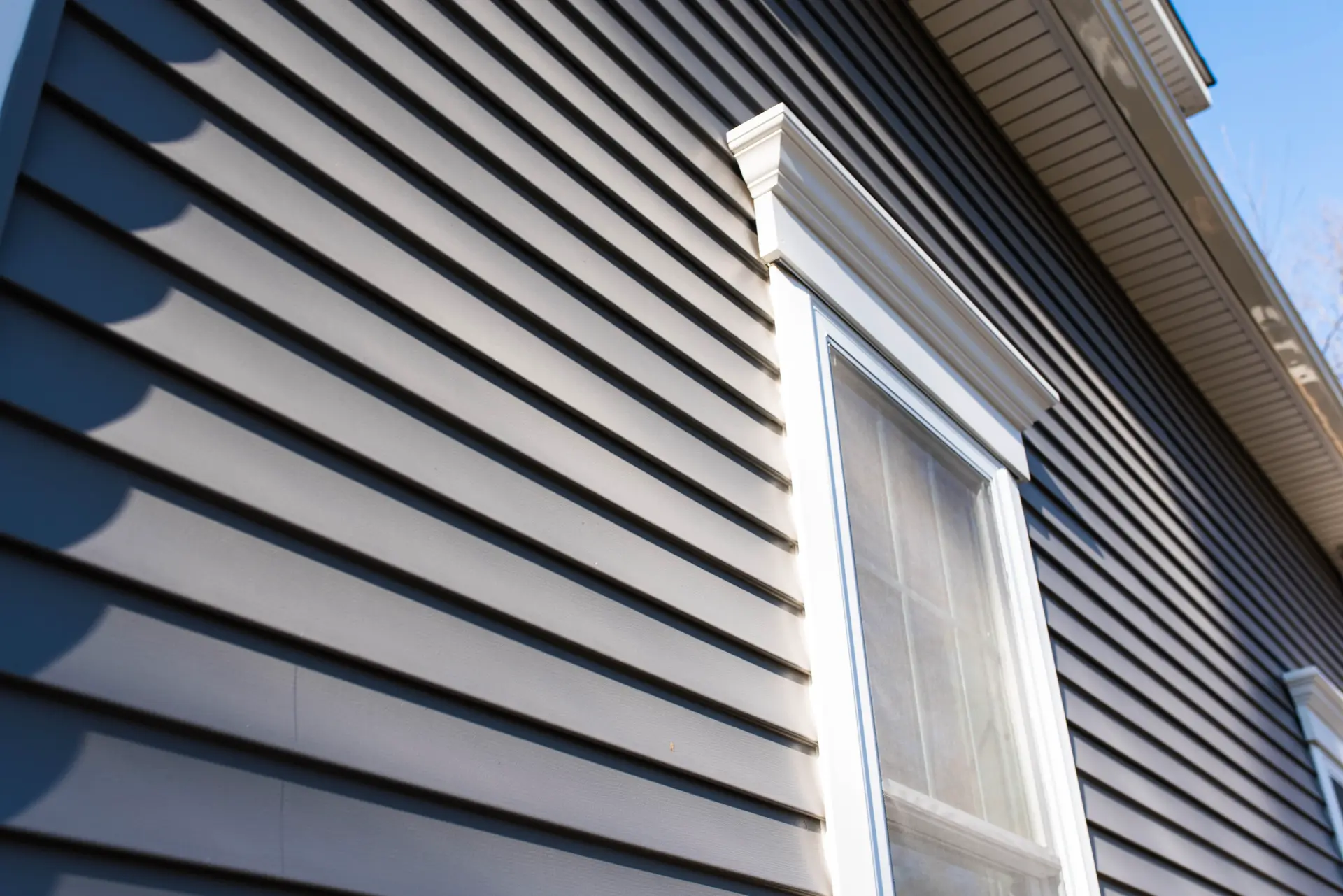Gray Siding On House With Windows Facing Sky